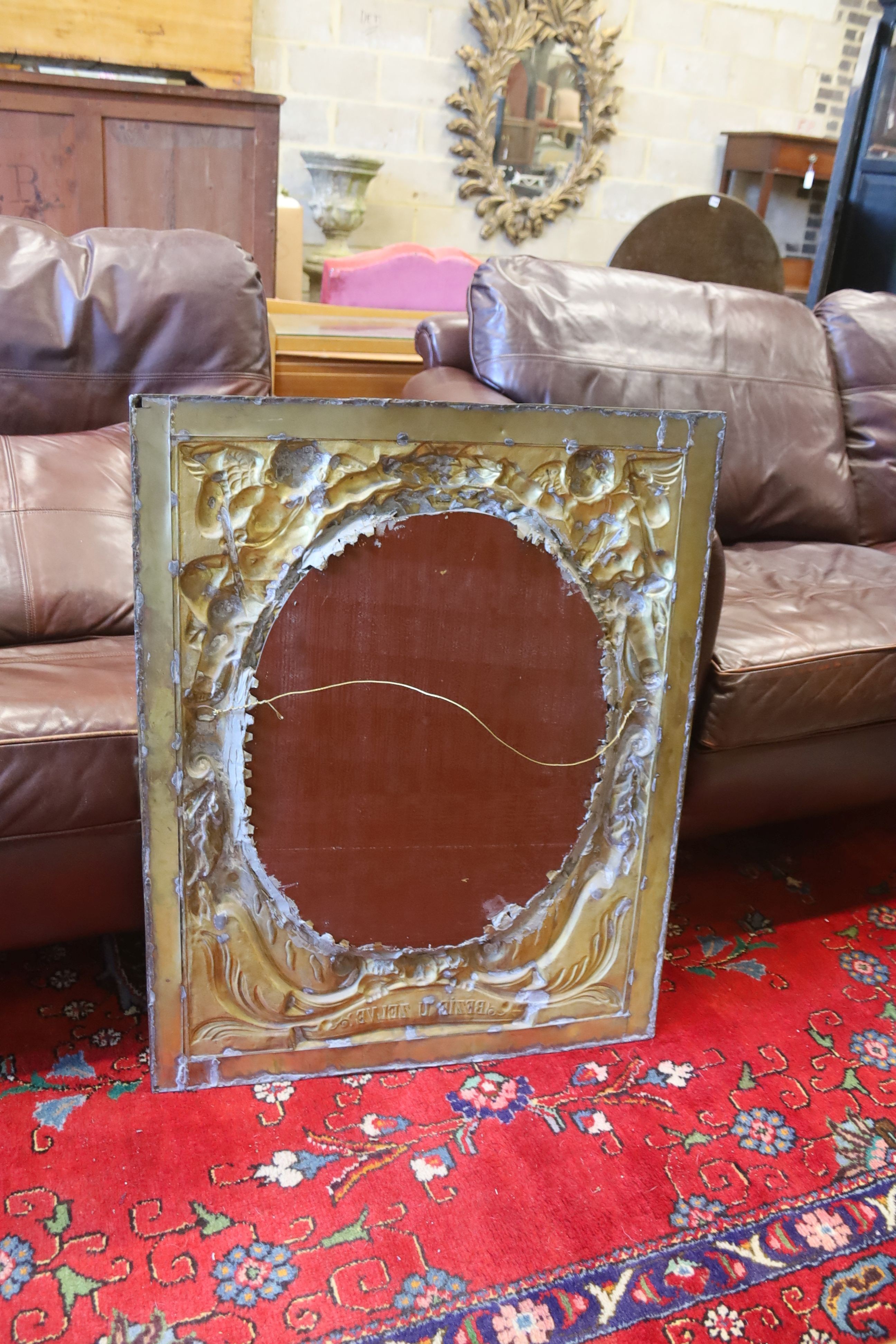 A pair of late 19th/early 20th century Dutch embossed brass framed mirrors with oval plates, width 66cm, height 84cm